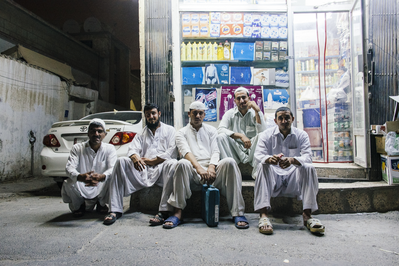Msheireb, Qatar street scene, Old Doha, men sitting, bodega, store, stoop, street corner, night